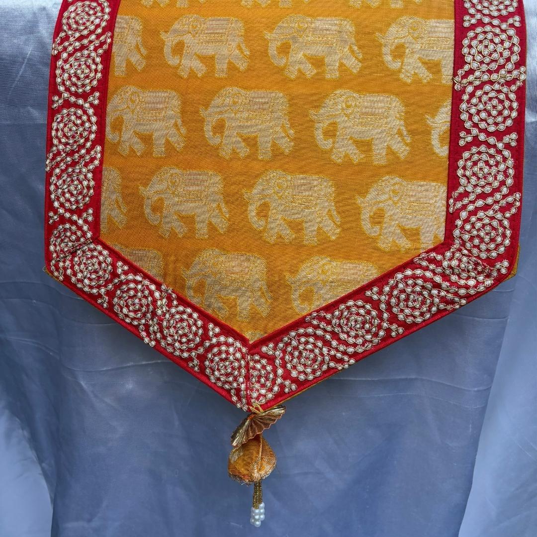 Decorative table runner with elephant pattern on a yellow background