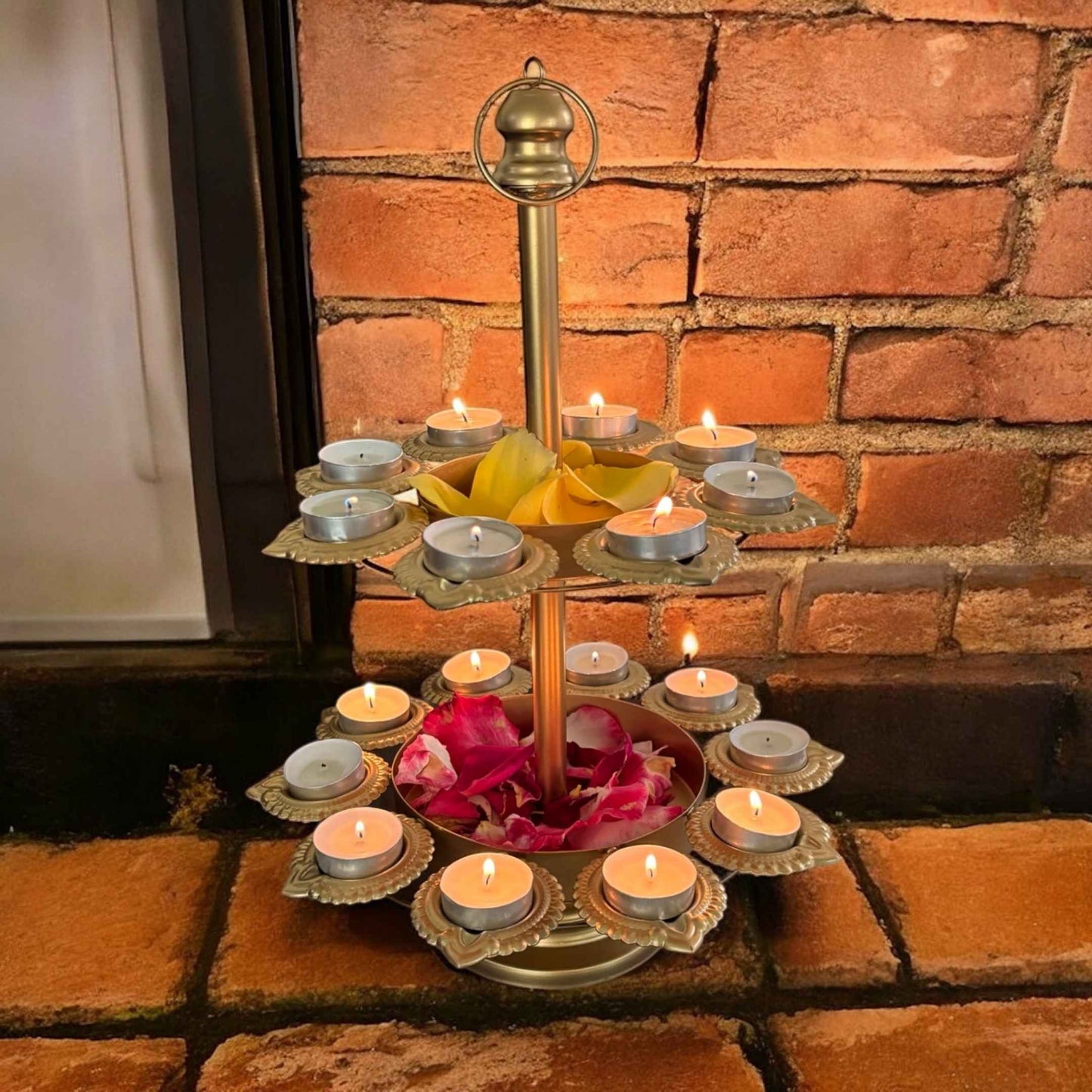 Decorative oil lamp with candles on a brick surface