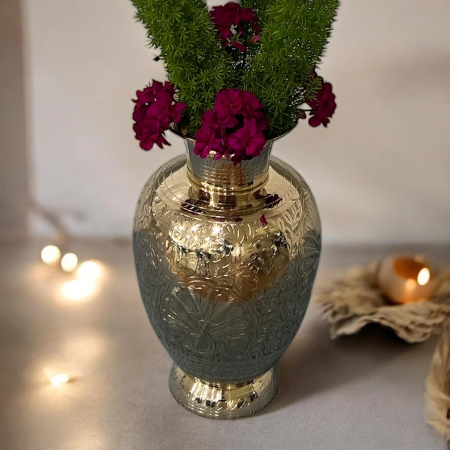 Front view of an 11.5-inch tall handmade brass vase with intricate floral engravings and a polished gold finish