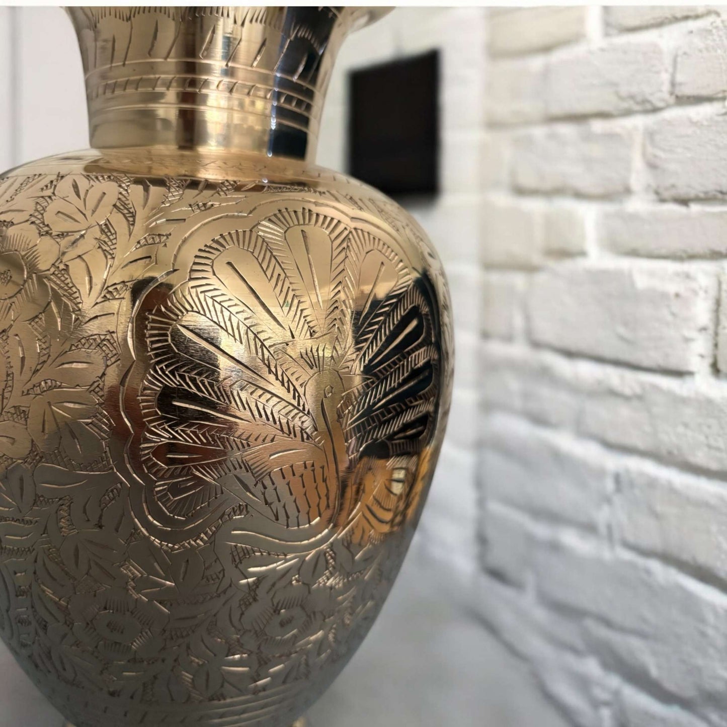 Detailed close-up of the vase's hand-engraved floral motifs, emphasizing craftsmanship