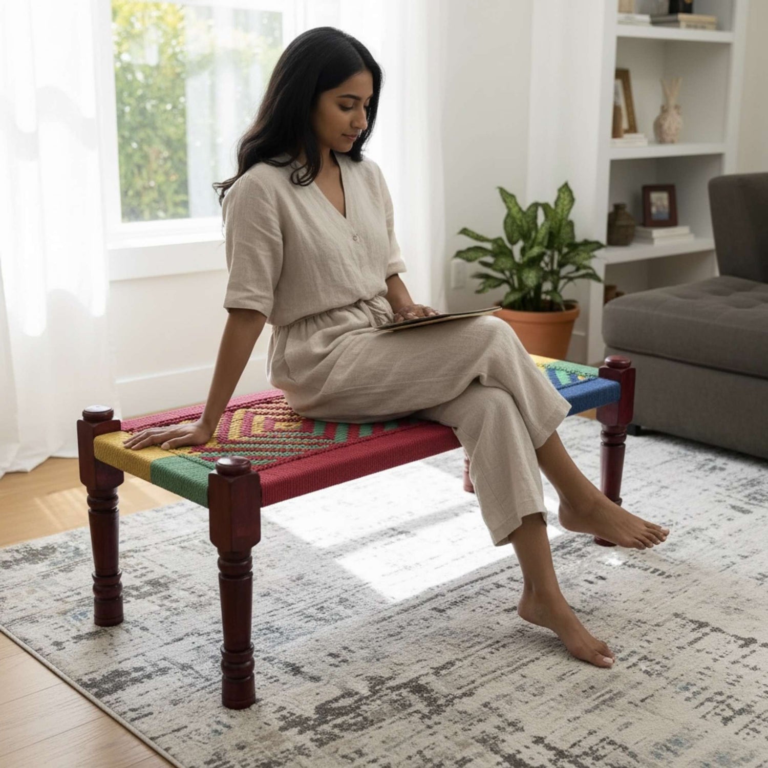 Handwoven charpai bench and stool styled in a modern boho living room