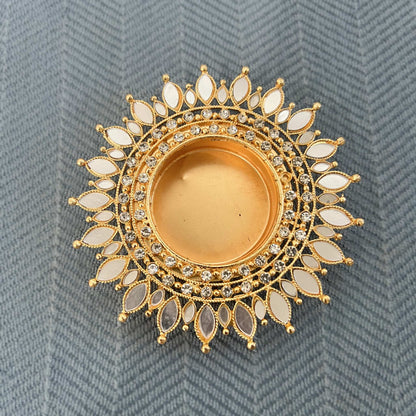 Close-up of a gold mirror sunflower tea light holder with radiating white mirror petals