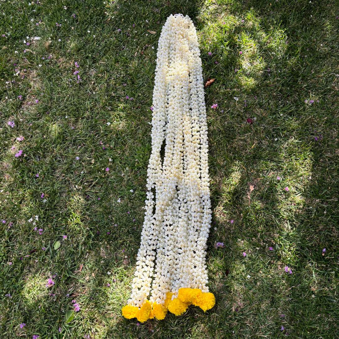 Garland Hanging on Doorway - 5FT long Urli Utsav's Mogra and bell garland adorning a doorway, enhancing home entrance with traditional Indian festive decoration