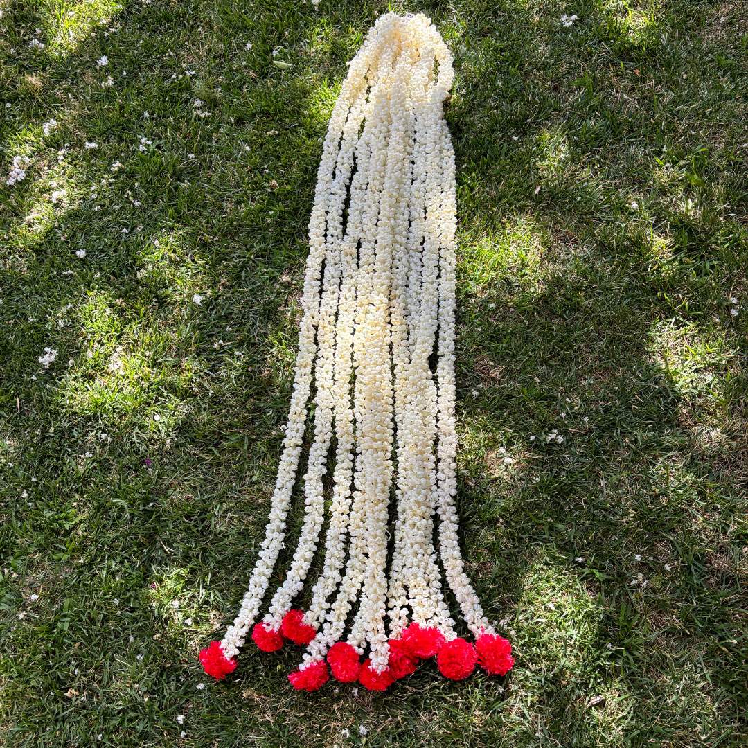 Detailed view of 5 feet long handcrafted artificial Mogra flowers and golden bells on Urli Utsav's Indian garland, showcasing intricate design and craftsmanship