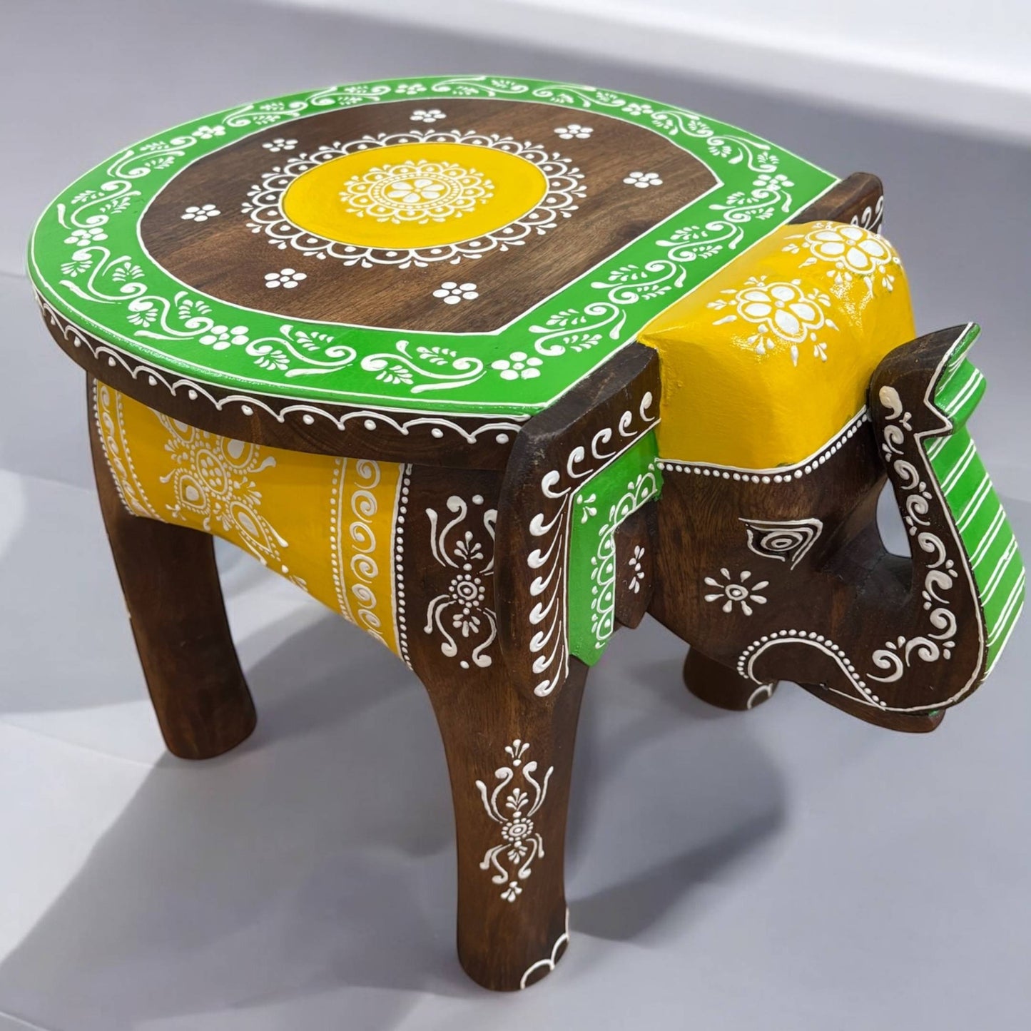 Brown Green Elephant Stool - Office room furniture, Versatile elephant stool used as an accent piece in a cozy seating area