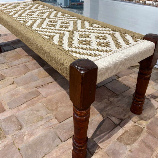 Handwoven Charpai bench with rustic jute cord seating, featuring a sleek silhouette and solid mango wood frame.
