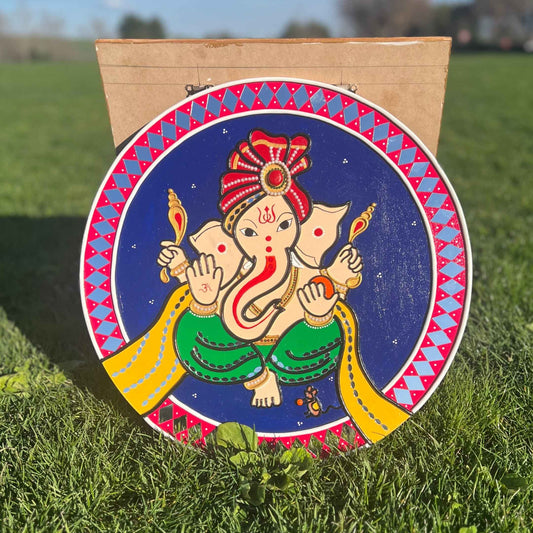 Lippan mirror-mosaic art of Lord Ganesha in green attire with red-gold headdress, dark blue background
