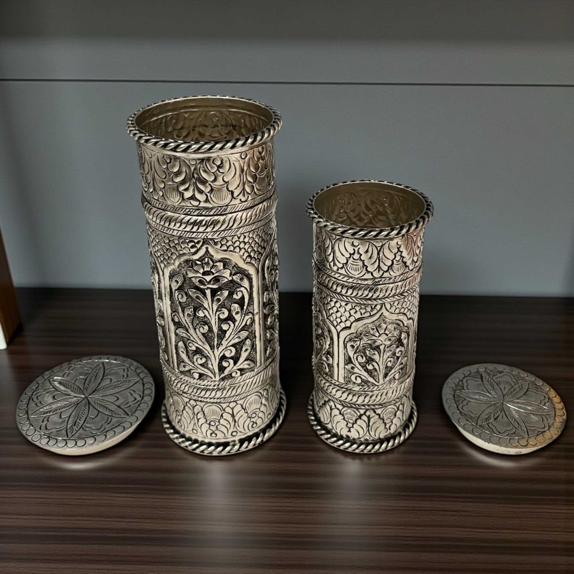 Close-up of traditional hand-chased floral engravings on silver-plated copper flower pots from Urli Utsav.