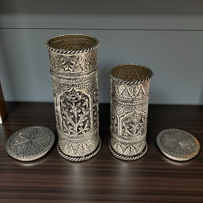 Close-up of traditional hand-chased floral engravings on silver-plated copper flower pots from Urli Utsav.