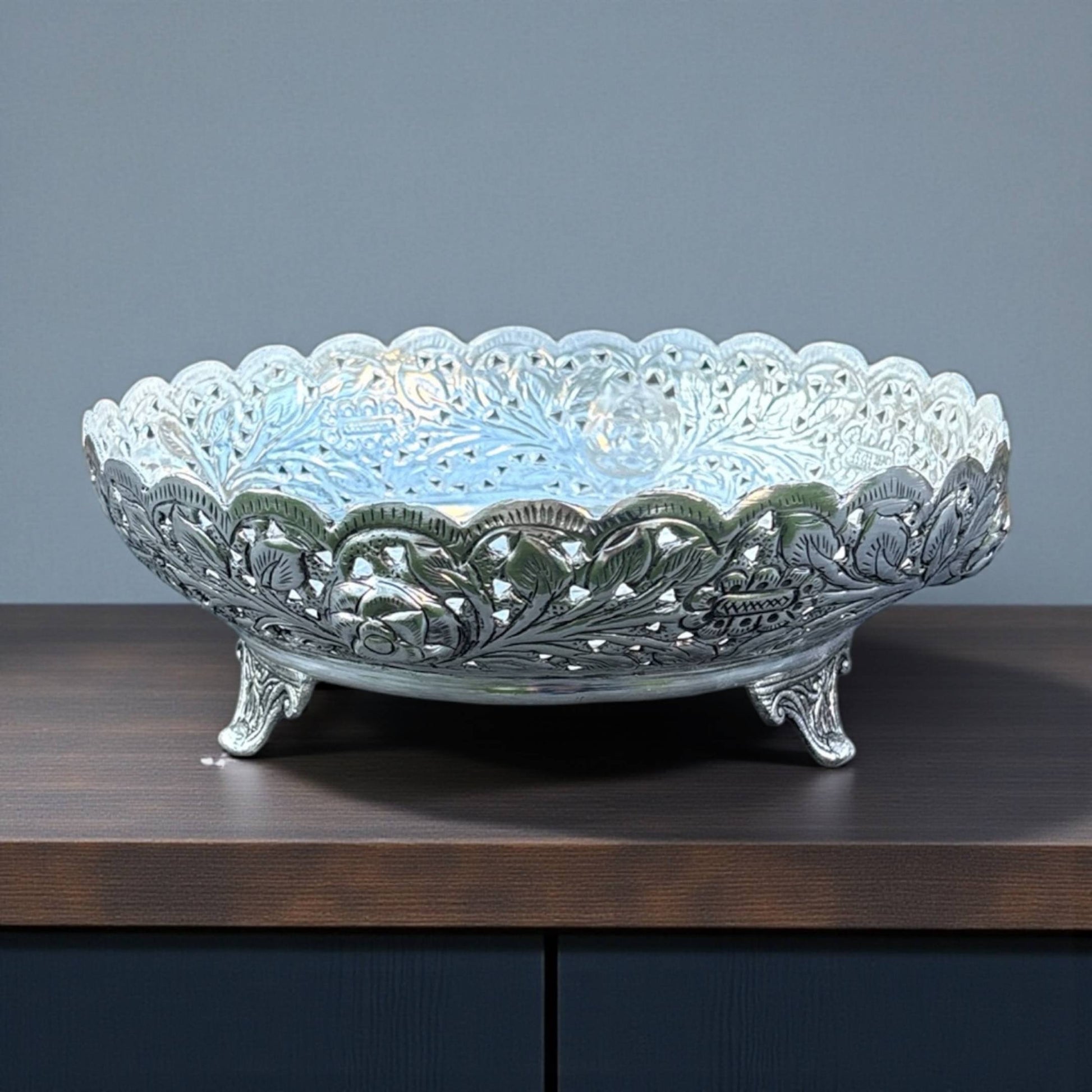 Urli Utsav decor decorative silver fruit bowl empty on neutral background