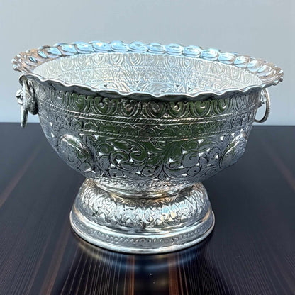Decorative silver bowl on wooden surface with intricate engraving – German silver fruit bowl