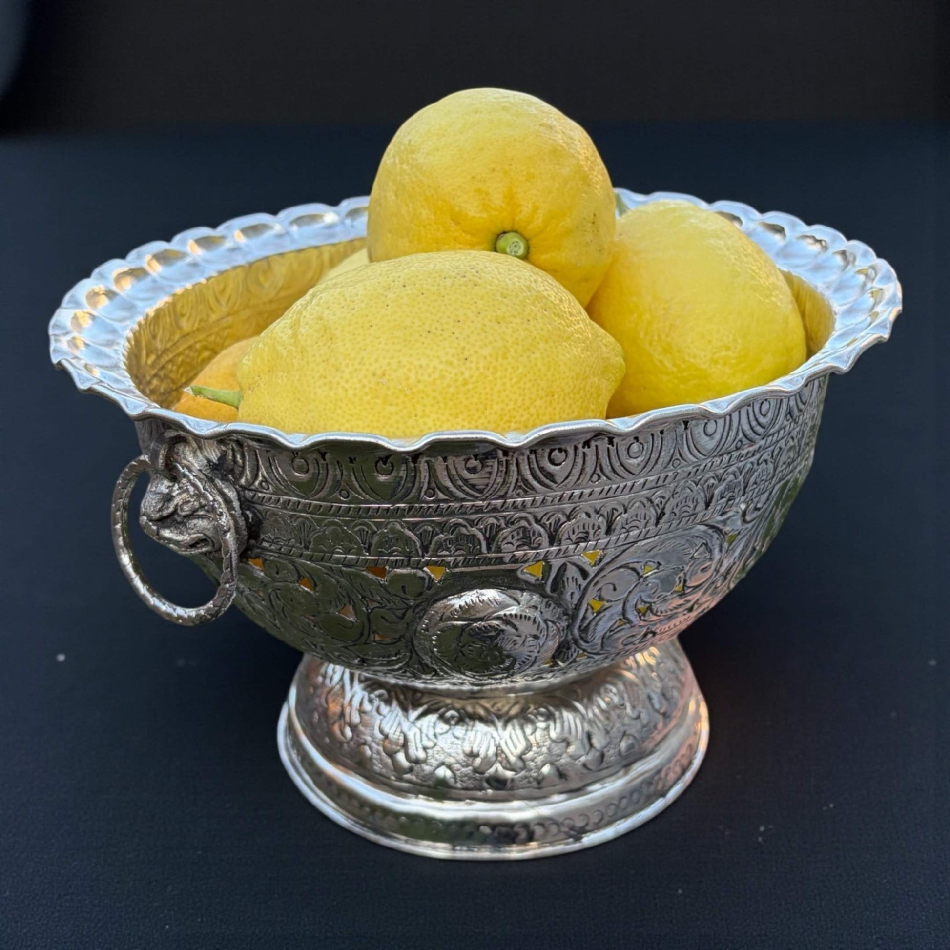 Fruit bowl with lemons and apples on wooden table with lights – Urli Utsav centerpiece décor