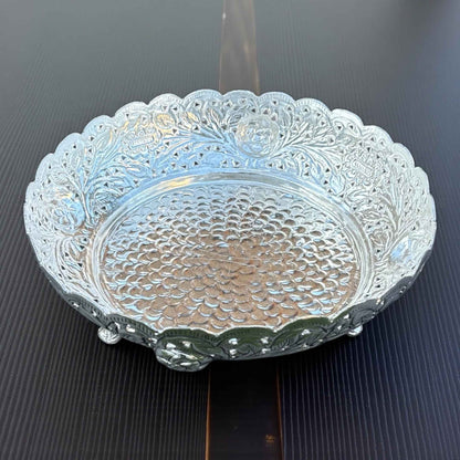 Close-up of German silver fruit bowl intricate antique silver pattern reflective surface