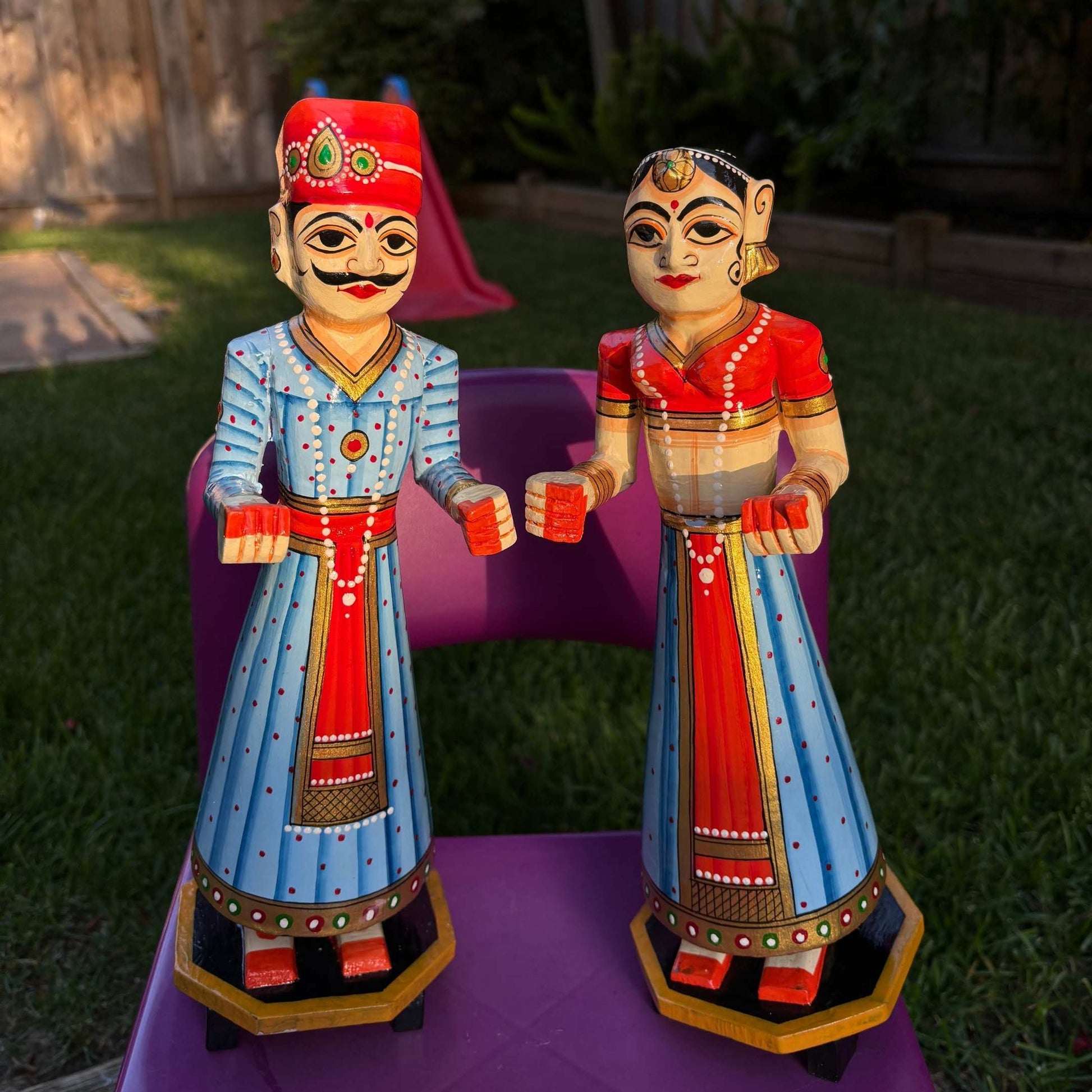 Isar Gangaur dolls, showing the smooth mango wood finish and vibrant blue paintwork 