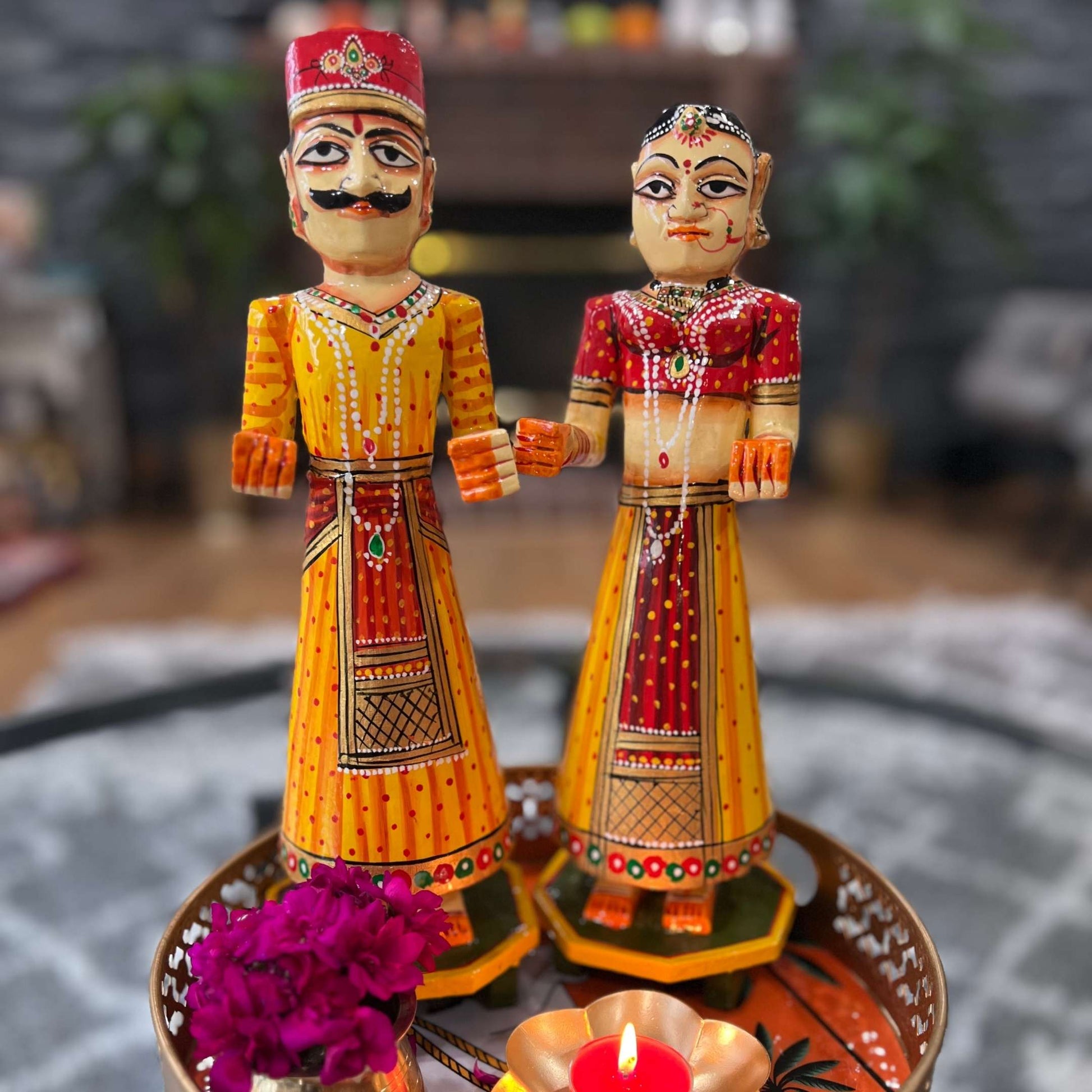 Isar Gangaur dolls, highlighting their detailed hand-painted yellow patterns and craftsmanship