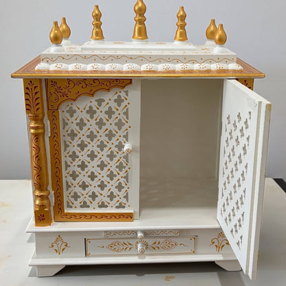 Decorative wooden Pooja Mandir with gold accents and open door on a plain background