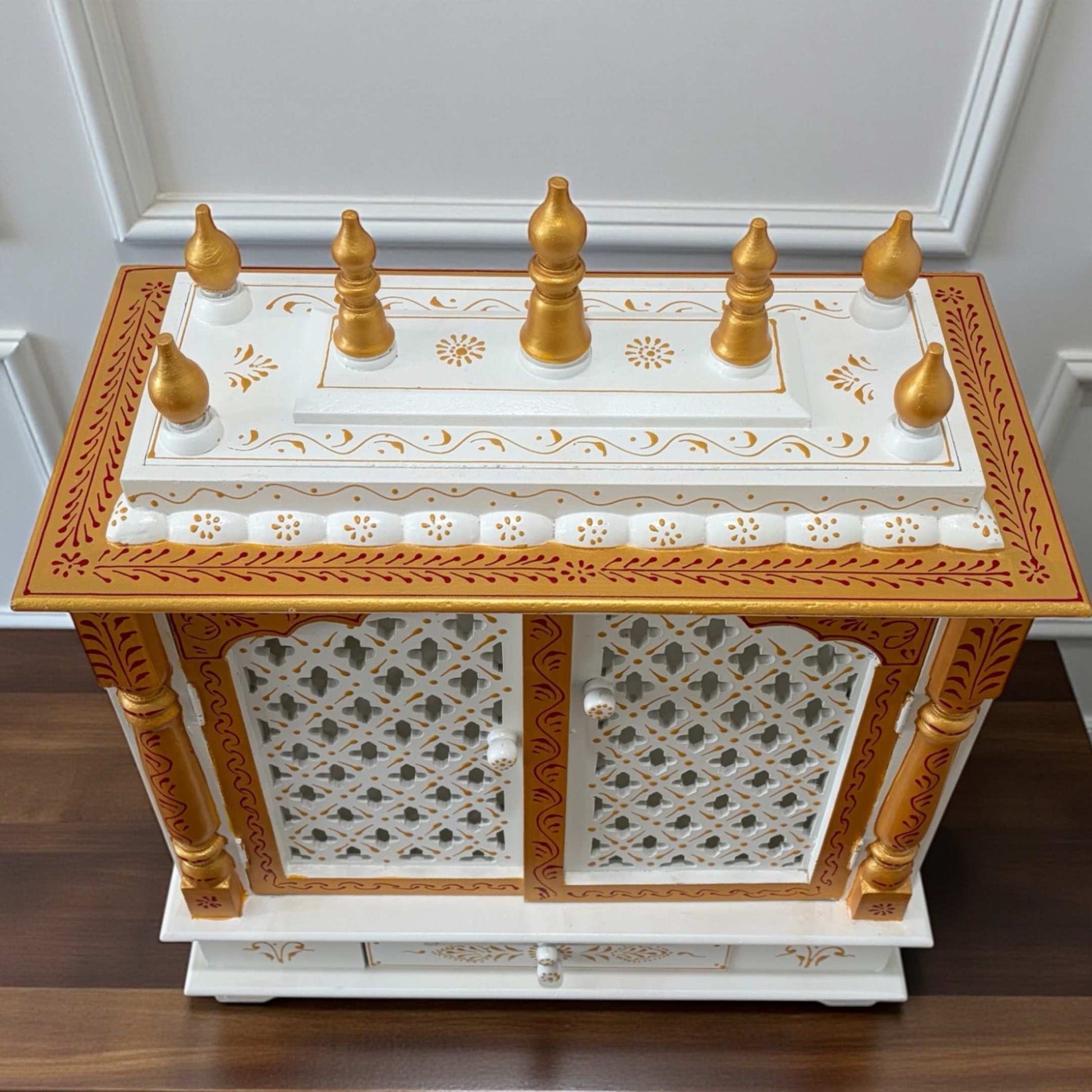 Top view highlighting gopuram of compact white and gold wooden pooja mandir – traditional temple style
