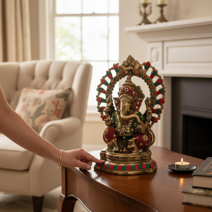 Close-up of an ornate brass Ganesh statue with a decorative crown and trunk detail, showcasing premium metalwork for spiritual home decor.