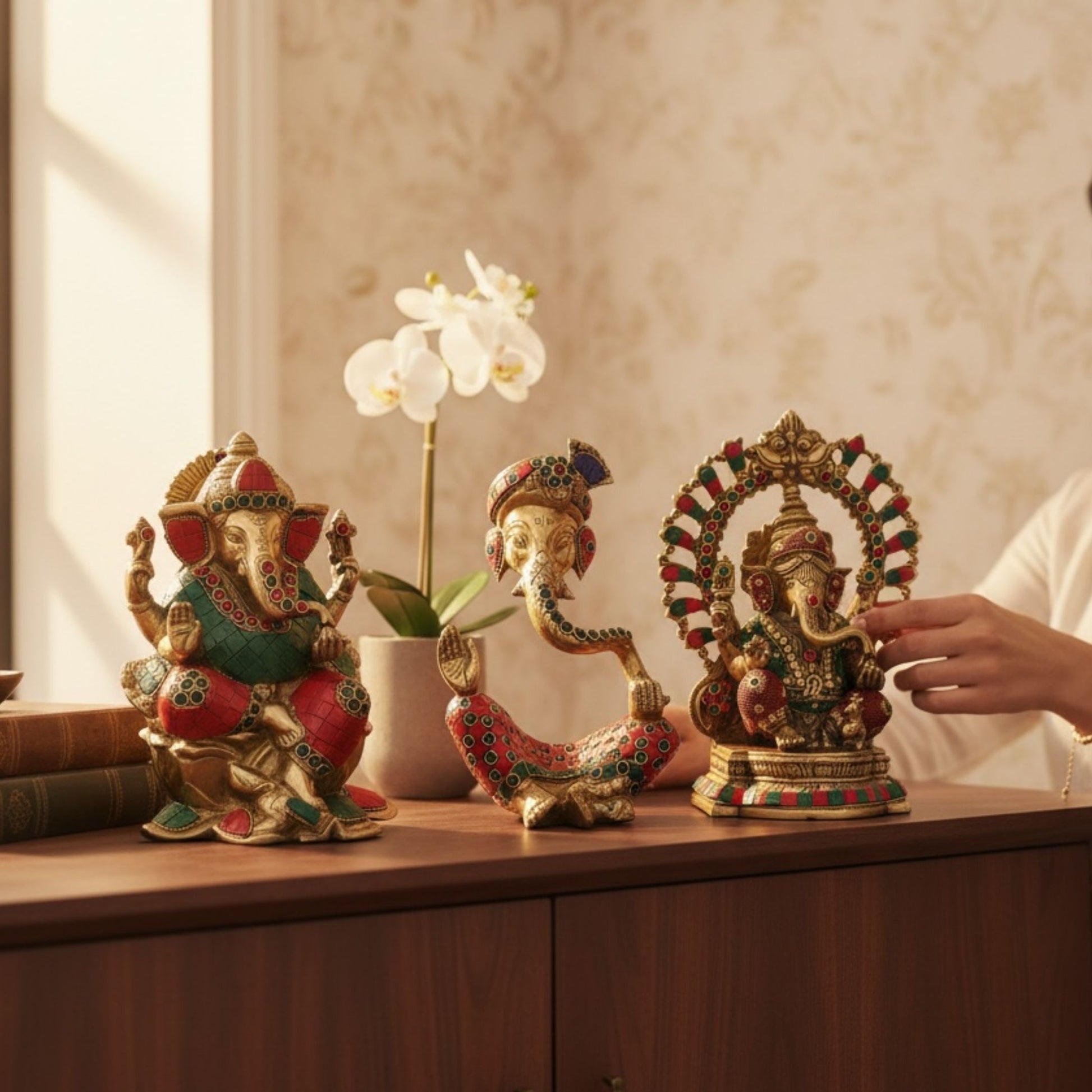 Three unique designs of Urli Utsav handcrafted brass Ganesha statues for home temple and office desk decor, showing detailed Indian craftsmanship
