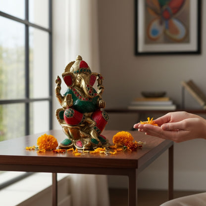 Hand-finished brass Lord Ganesha idol wearing a traditional dhoti, perfect for a small pooja mandir or as an auspicious housewarming gift.