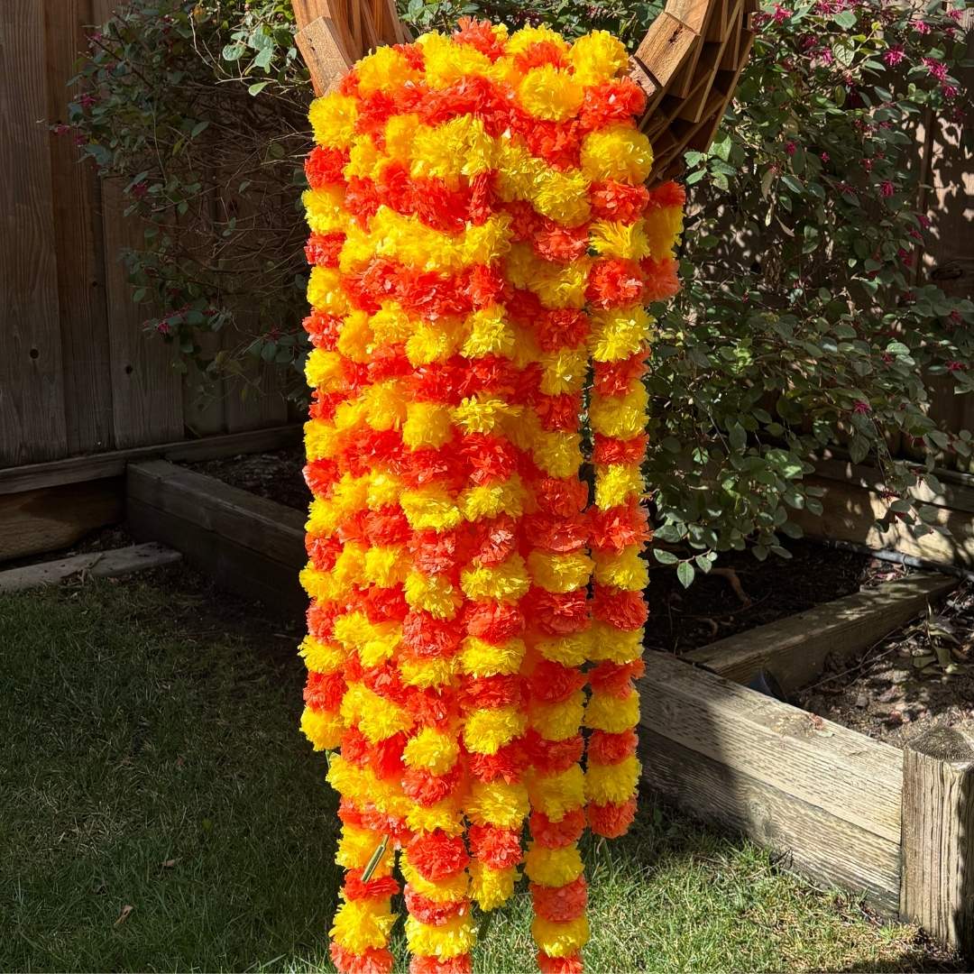 Close-up view highlighting the detailed craftsmanship of the artificial marigold flowers in yellow and orange colors, showcasing their realistic texture and rich colors