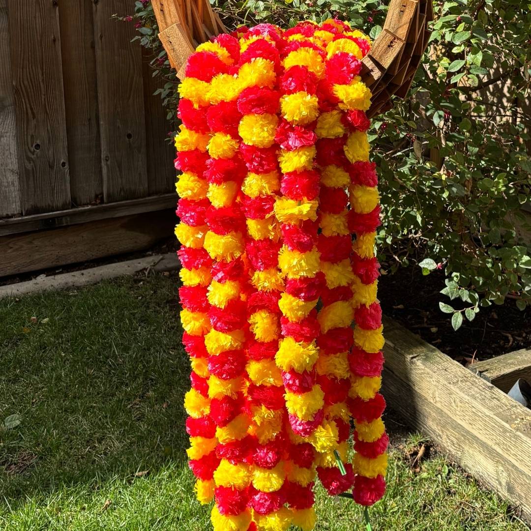The set of ten yellow red marigold garlands displayed in a fan arrangement, emphasizing the volume and decorative potential of the set