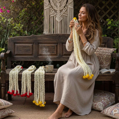 Woman sitting on a wooden bench with mogra garlands by urli utsav decor