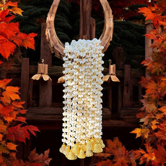 Garland Hanging on Doorway - 5FT long Urli Utsav's Mogra and bell garland adorning a doorway, enhancing home entrance with traditional Indian festive decoration.
