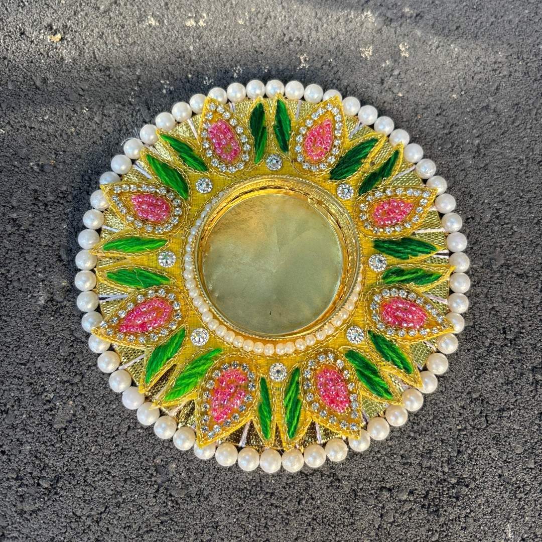 Top view of handcrafted T-light holder showing intricate pink-green floral stone work and pearl border on gold base.