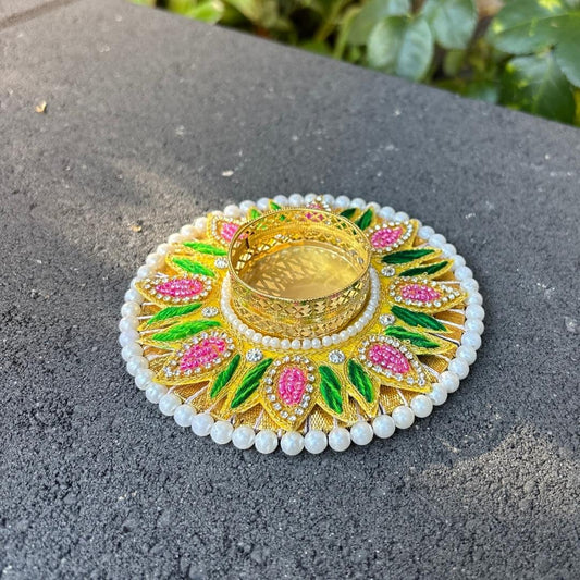 Multicolor pearl and stone work Diwali T-light holder on stone surface; gold base with pink and green floral design — Urli Utsav