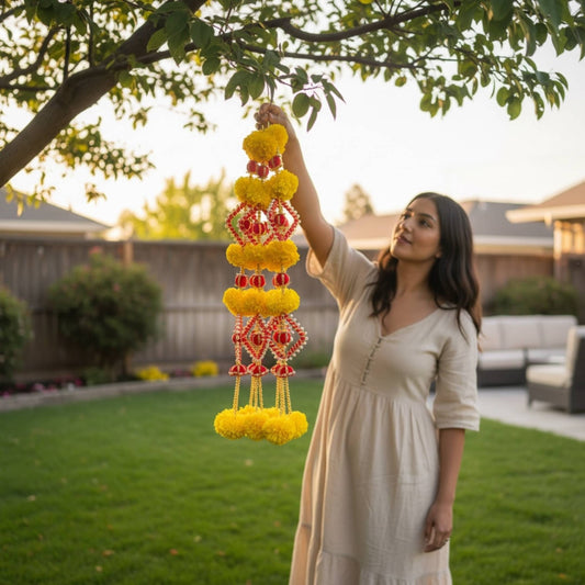 Woman holding a decorative hanging garland in a garden setting