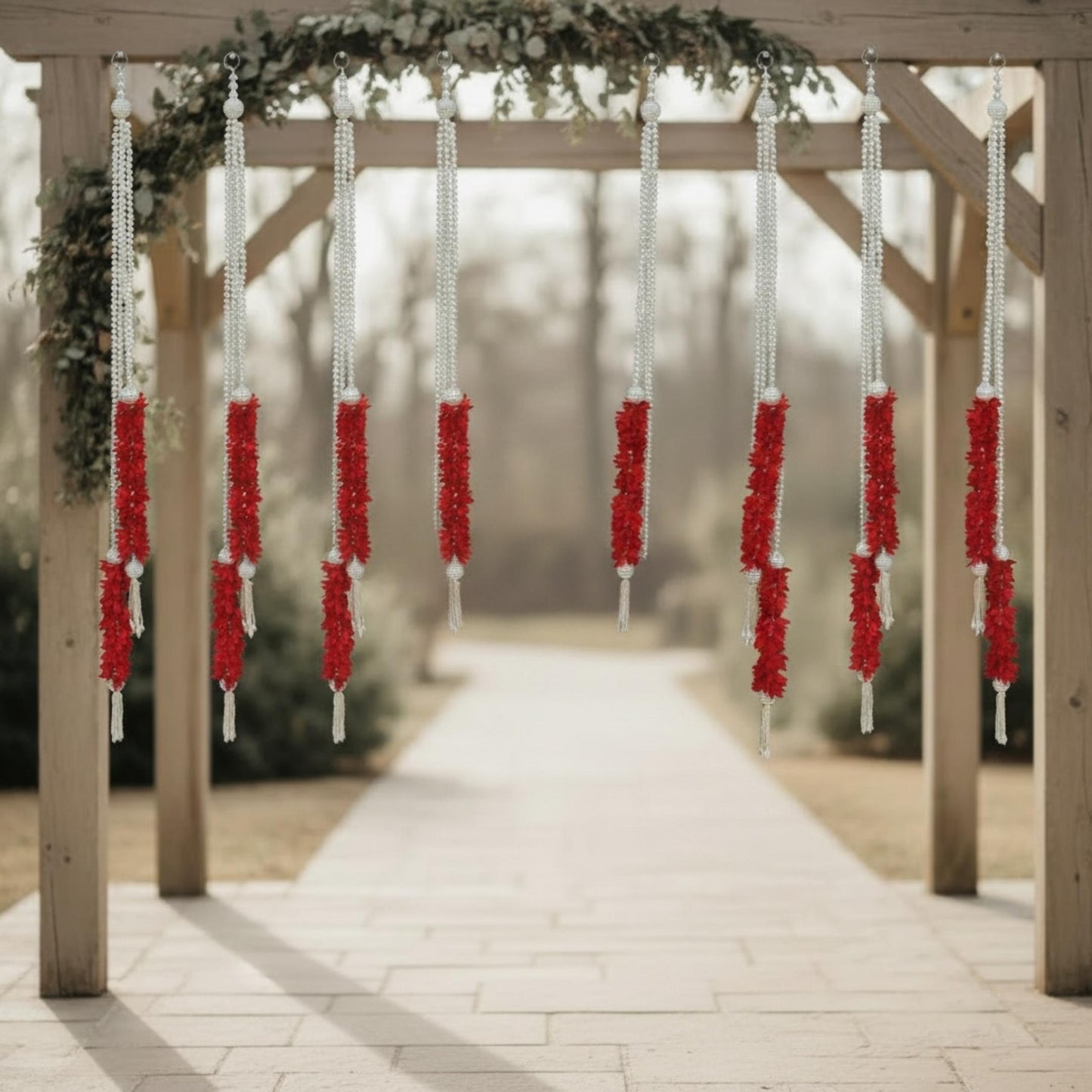 Red fabric garlands on outdoor wooden wedding arch – Indian mandap entrance décor