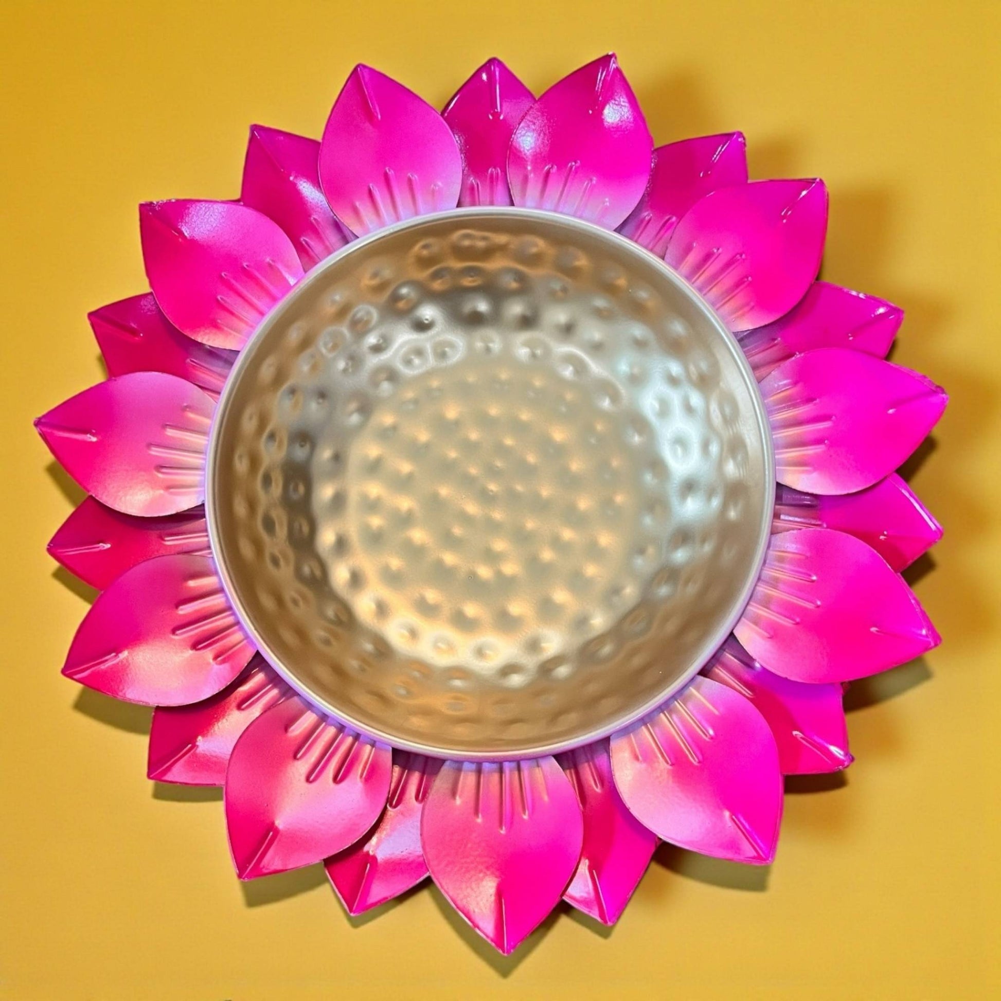 Close up photo of petal-like edges and a gold center urli bowl