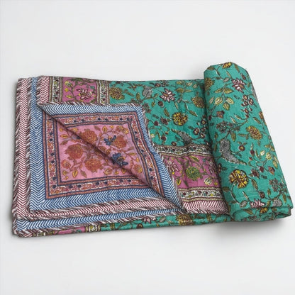 Reversible Indian Dohar showing two unique hand-blocked floral patterns in one lightweight cotton quilt.