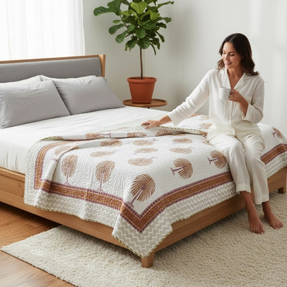 Lightweight AC throw quilt draped over a sofa, highlighting its use as a cozy living room blanket.