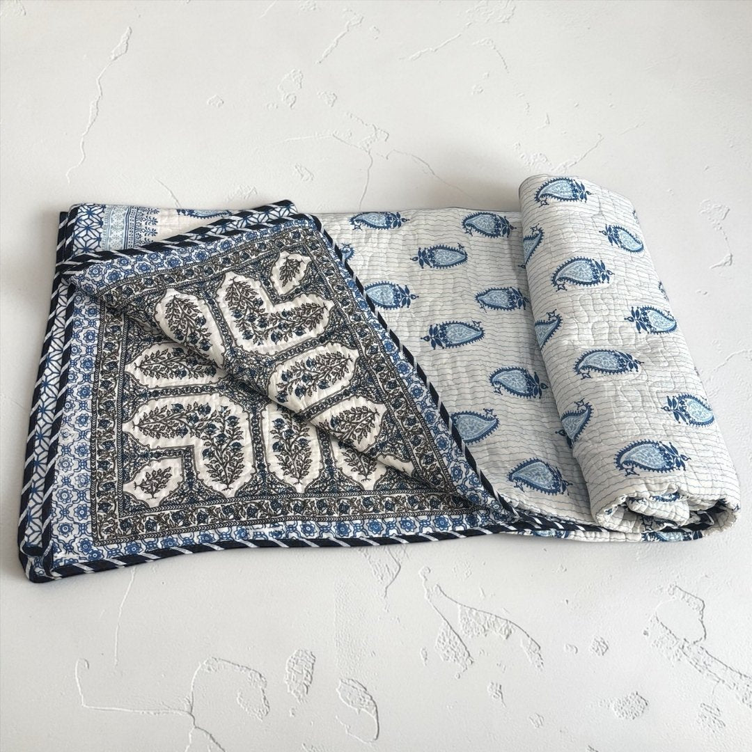 Traditional Paisley print king-size quilt featuring intricate hand-stamped motifs in classic Indian artistry.