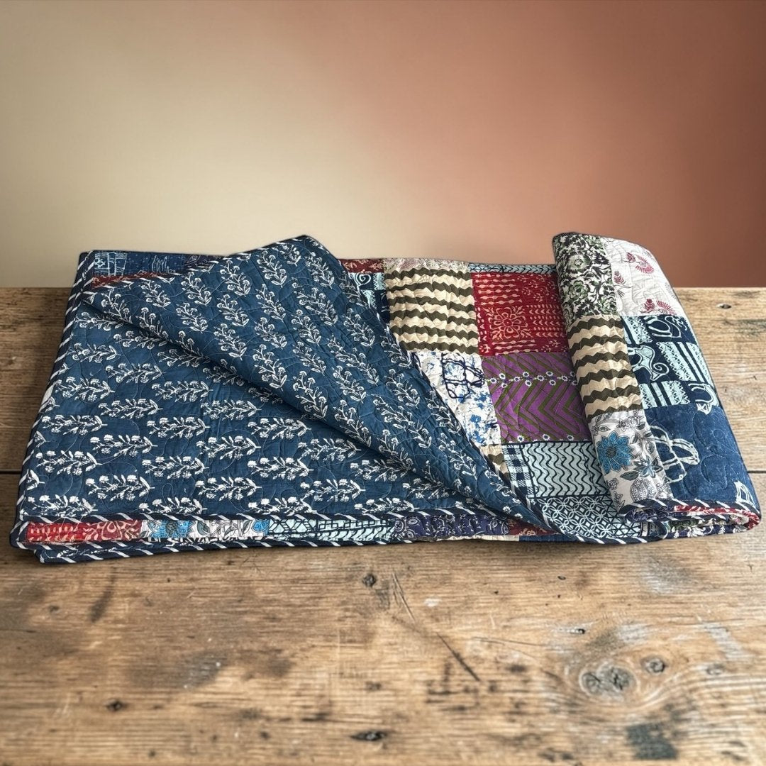 Urli Utsav Patchwork design Indian block print quilt with vibrant multi-pattern floral squares.