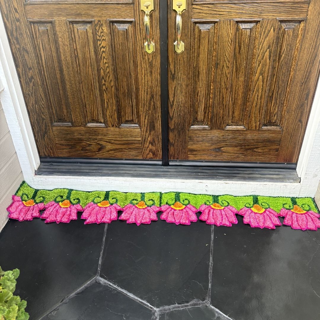 Handmade pink lotusrangoli mat placed at double front door Indian festive entry decor