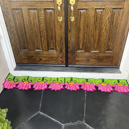 Handmade pink lotusrangoli mat placed at double front door Indian festive entry decor