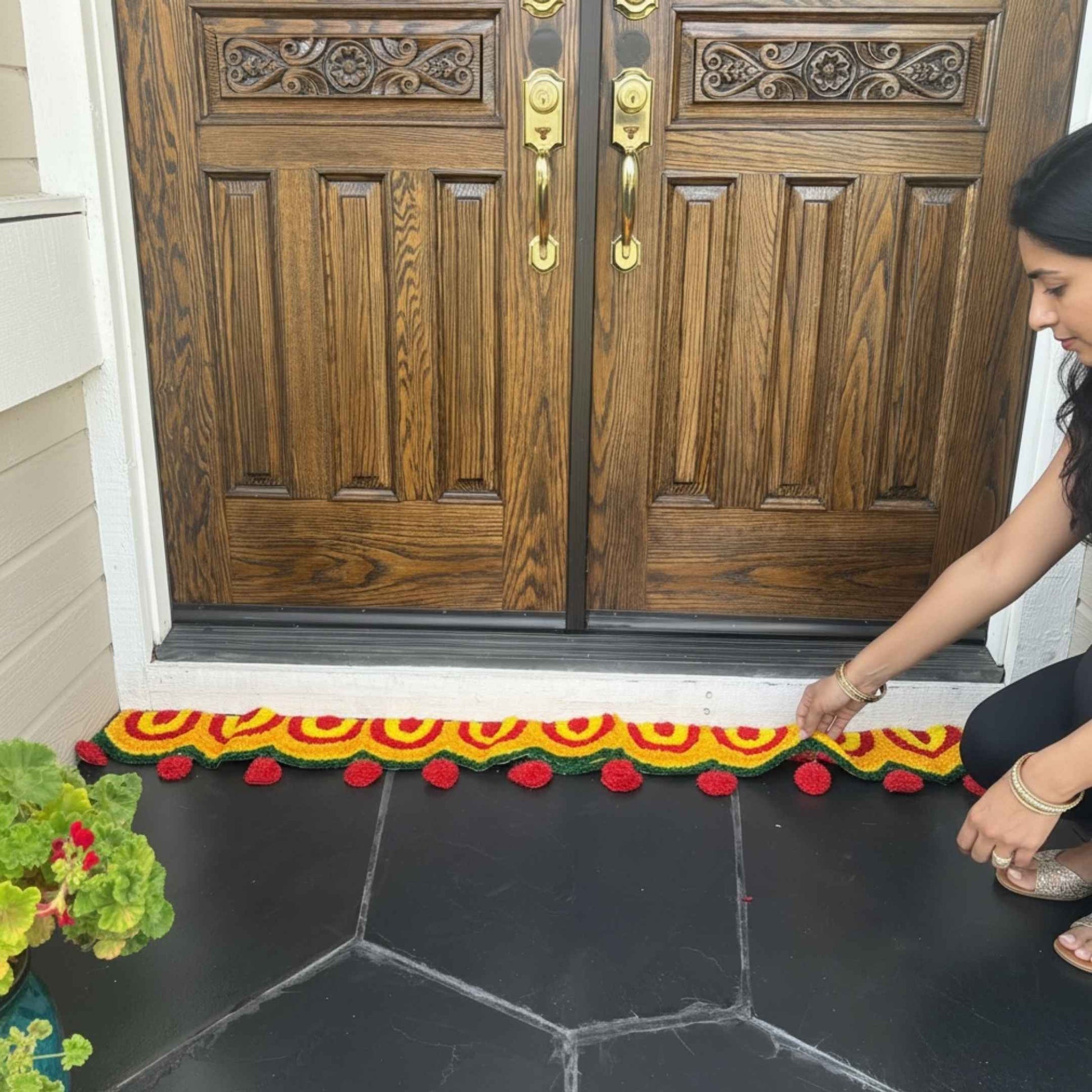 indian classic decorative mat in front of main entry double doors. 