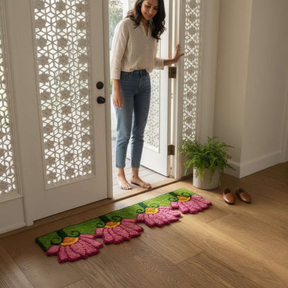 Woman at doorway with pink lotus rangoli mat Indian home entry Diwali housewarming decor