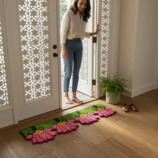 Woman at doorway with pink lotus rangoli mat Indian home entry Diwali housewarming decor