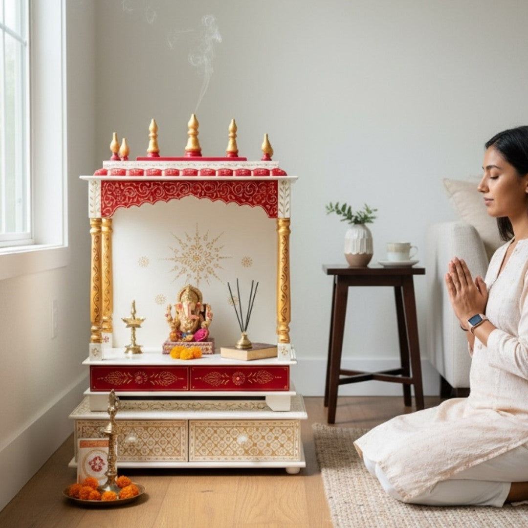 Woman praying in front of a urli utsav red white mandir  - pooja setup
