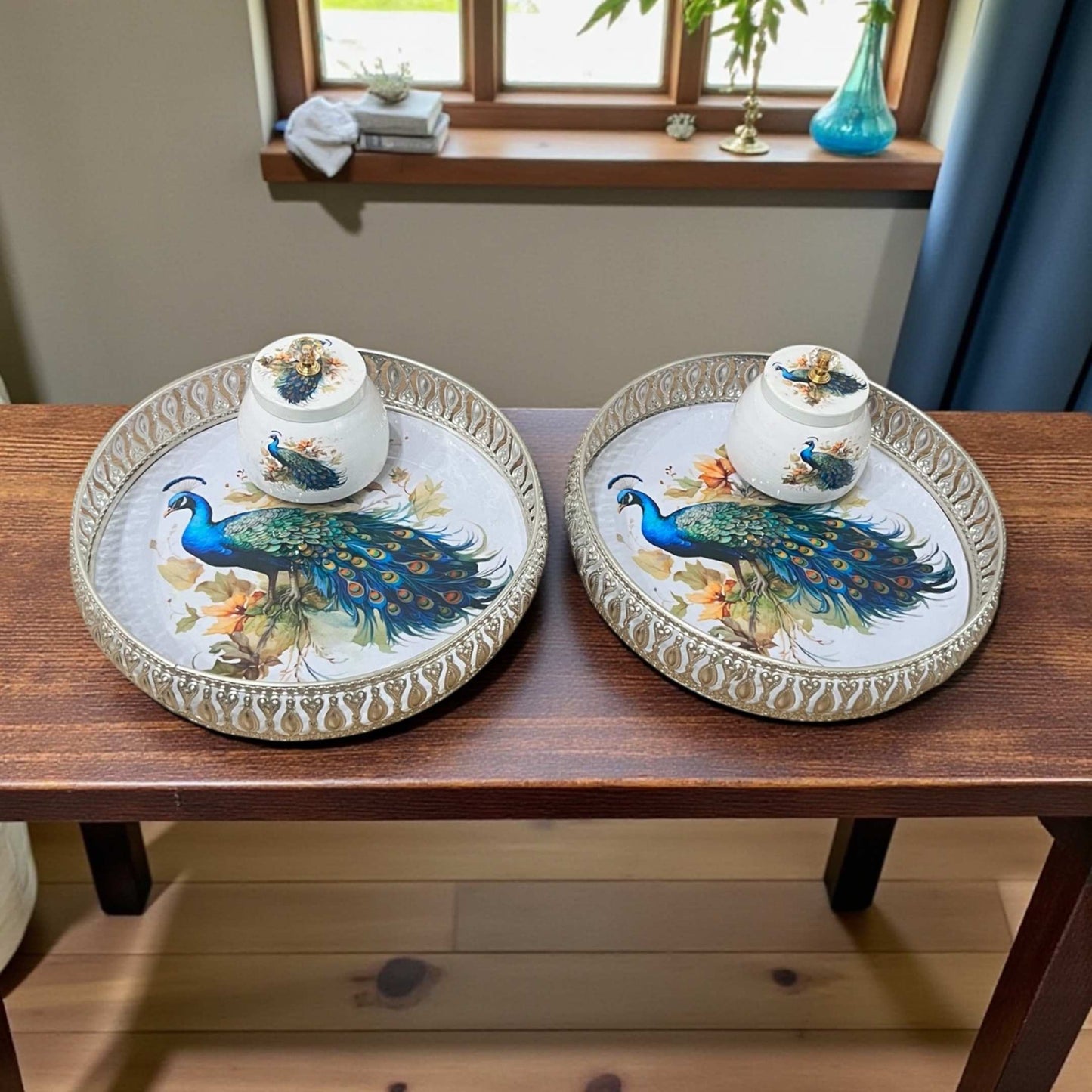 Set of two German silver Pichwai art trays with intricate pattern displayed on wooden dining table