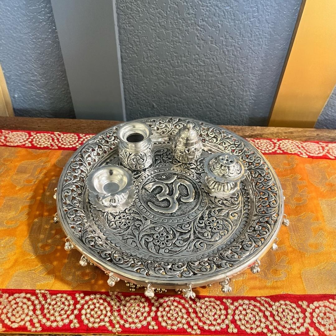 Elegant silver pooja thali set arranged for a spiritual ritual, perfect for Diwali gifting or housewarming celebrations.