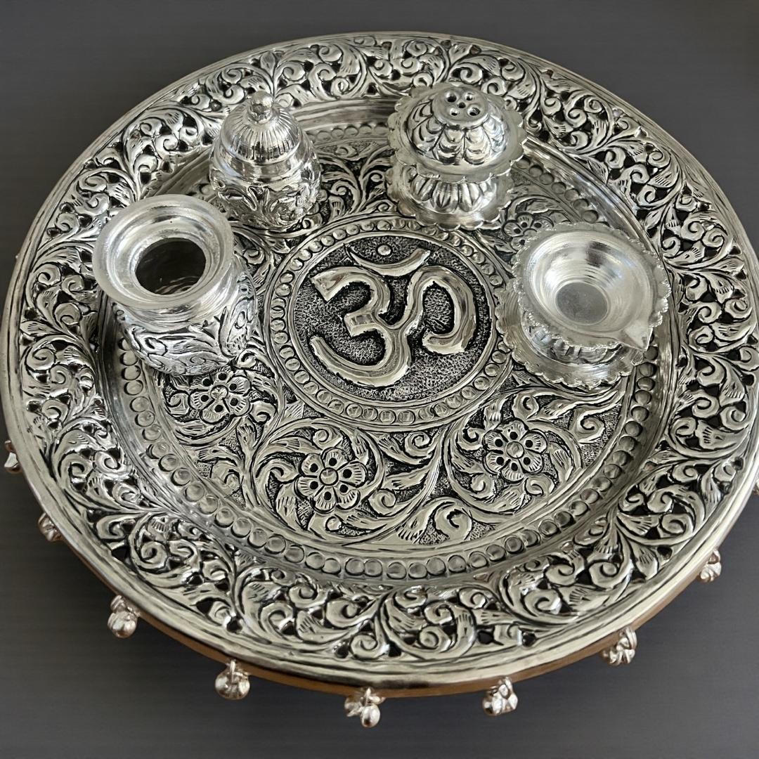 11-inch Om Pooja Thali Set in antique silver-plated brass featuring a central Om motif, Kalash, Agarbatti stand, and Kumkum box for Laxmi Puja 2026.