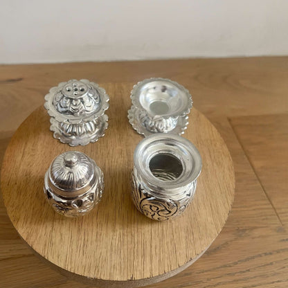 Antique silver-plated pooja accessories including a 3-inch Kalash lota, incense holder, and mini oil stand with intricate handmade engravings.