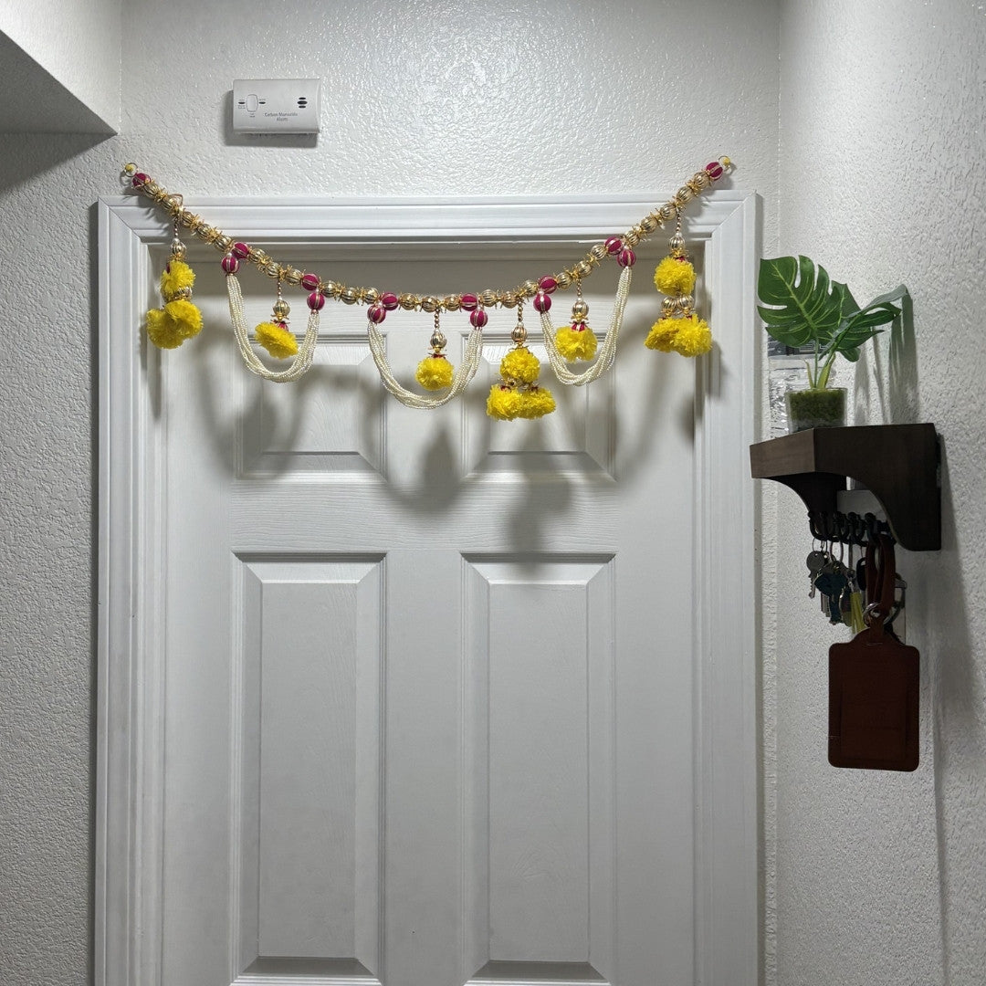 Pearl marigold toran bandhanwar on white interior door in Indian American home — festive door garland for everyday decor
