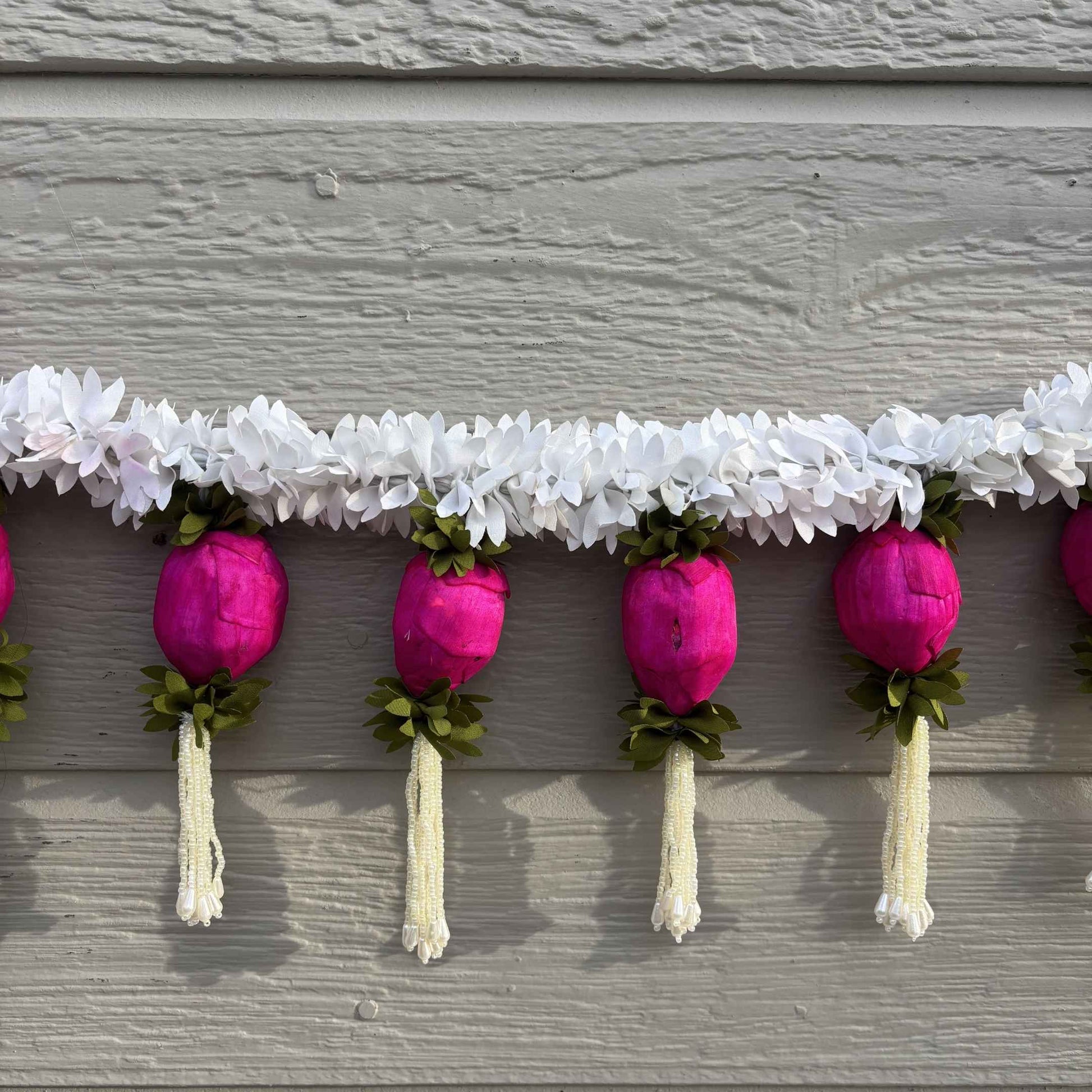 Detailed view of handcrafted artificial jasmine flowers and pink Sola wood lotus buds for festive Indian decor.