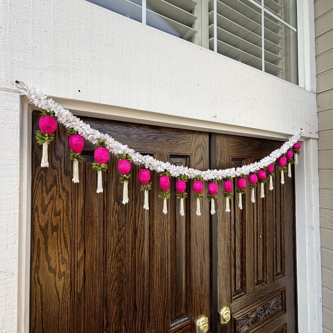 Handcrafted Indian door torana or bandhanwar with white jasmine flowers and colorful sola wood buds
